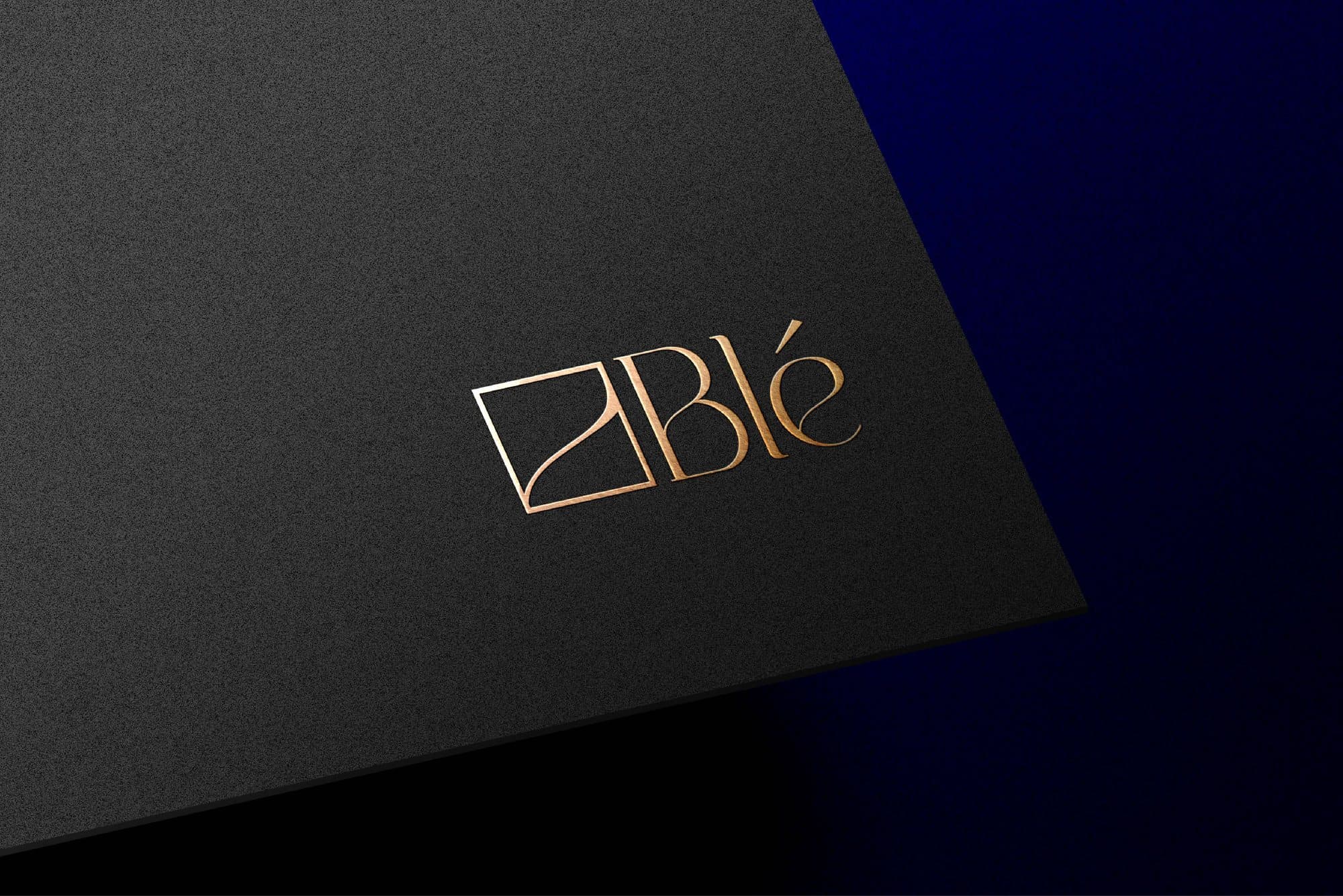 The Blé wordmark foiled in gold on black stock
