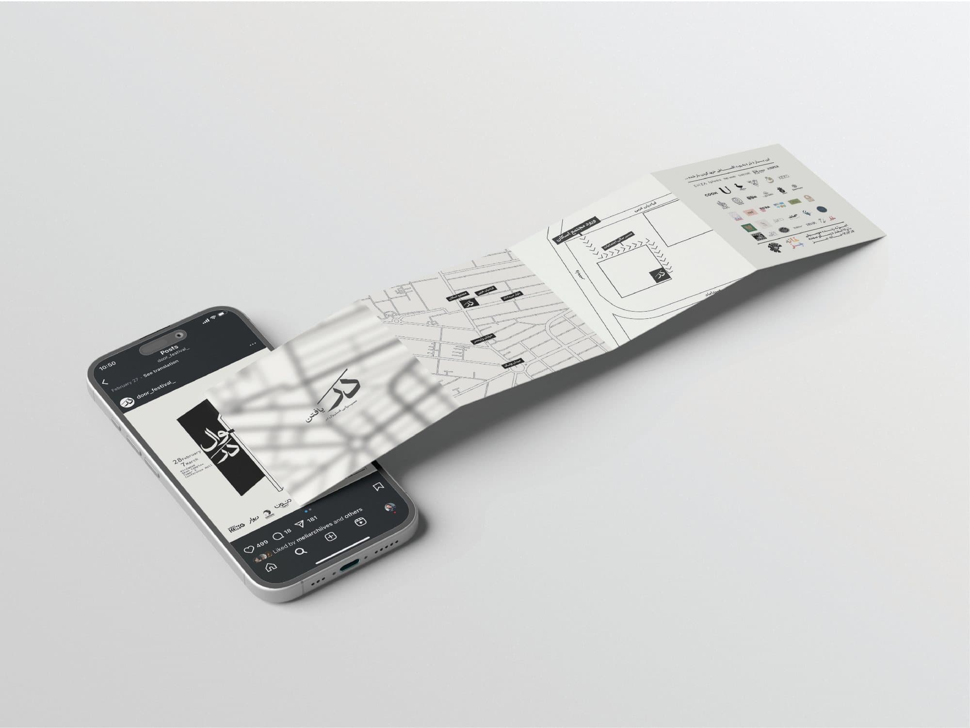 The printed festival programme unfolded beside the phone
