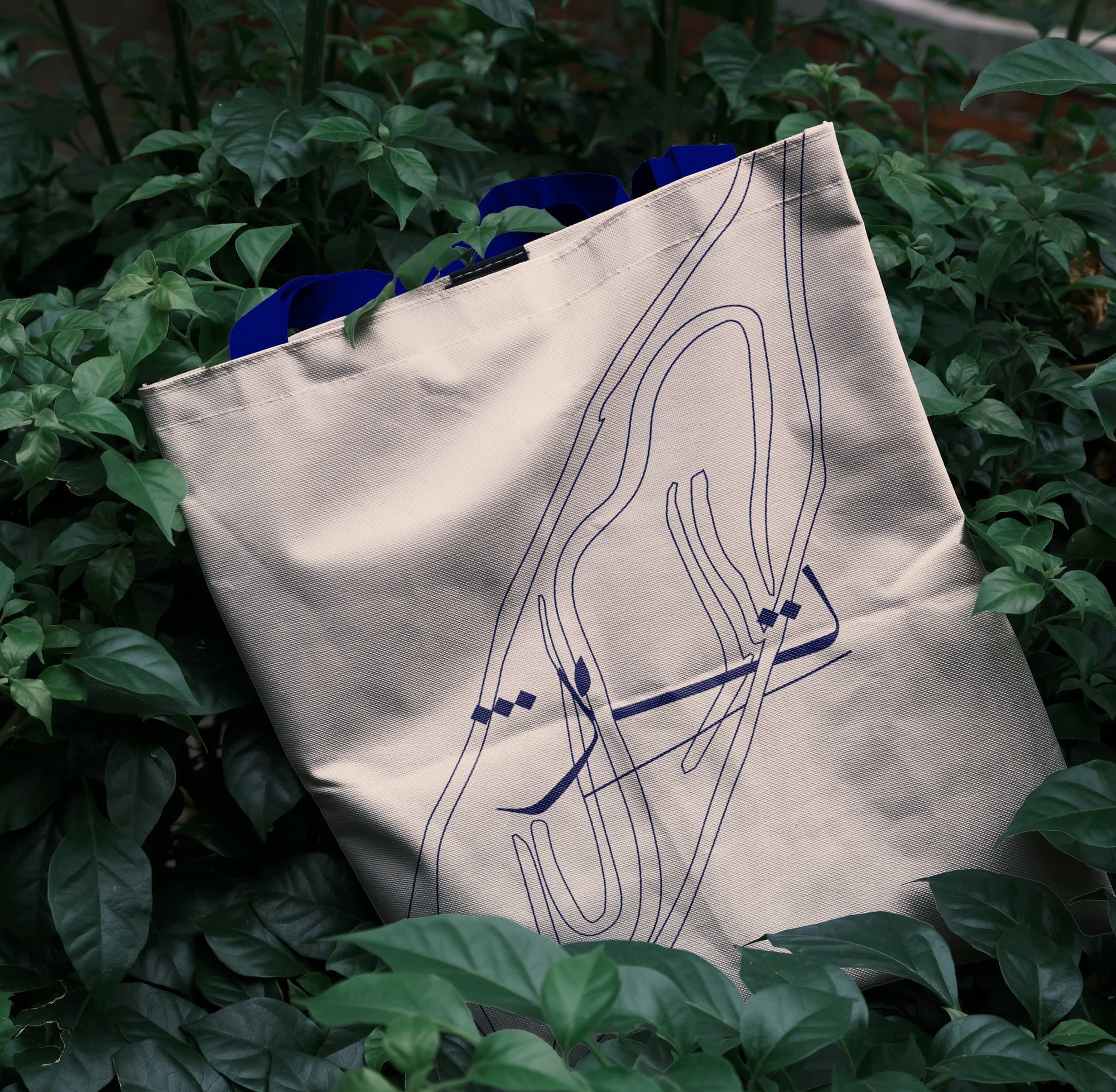 Printed tote bag among foliage